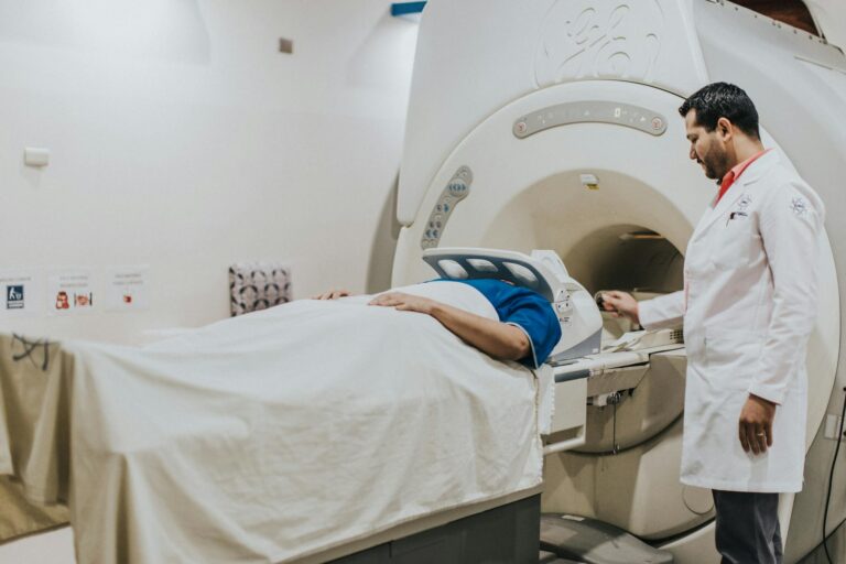 A doctor assists a patient during an MRI scan in a hospital setting, highlighting modern healthcare technology.