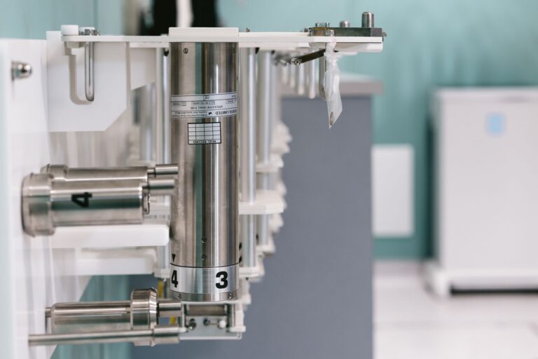 Close-up of metal laboratory apparatus in a sterile research lab environment.