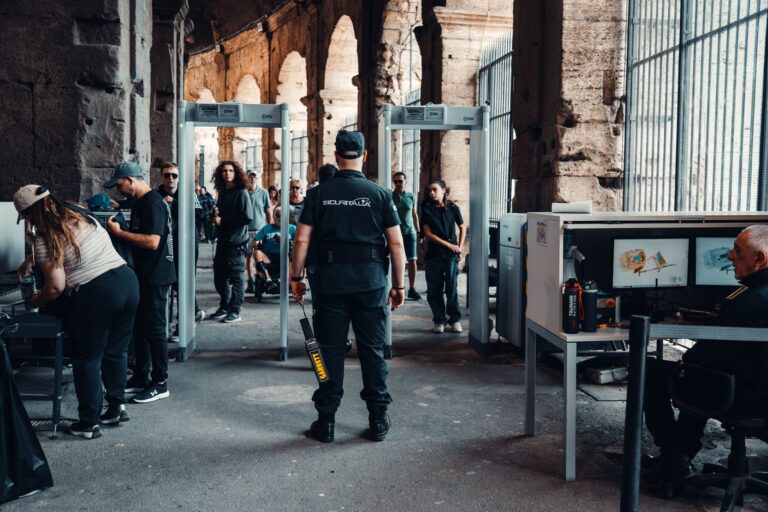 Security checkpoint with guards at a bustling historical site entrance.