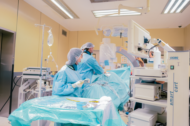 Surgical team in Baku, Azerbaijan operating room with advanced equipment and sterile environment.