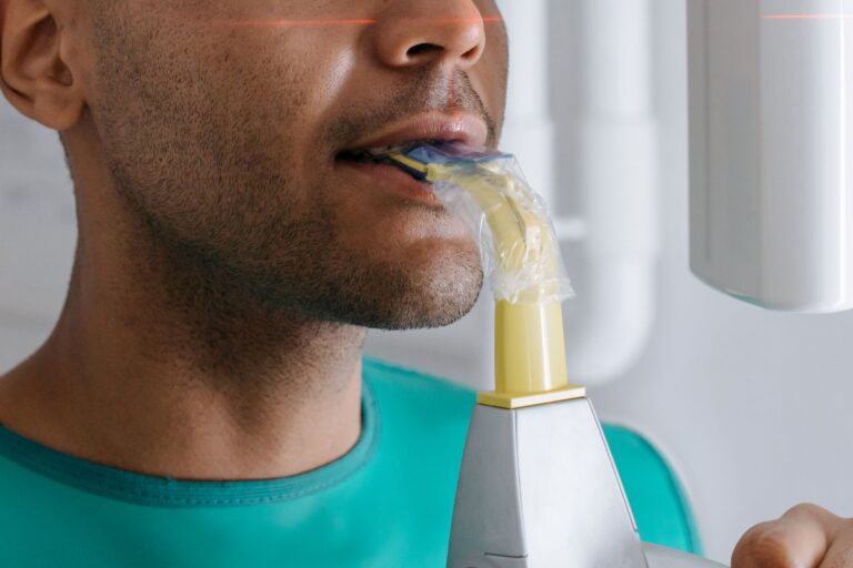 Close-up of a man undergoing a dental x-ray scan at a clinic, focusing on oral health.