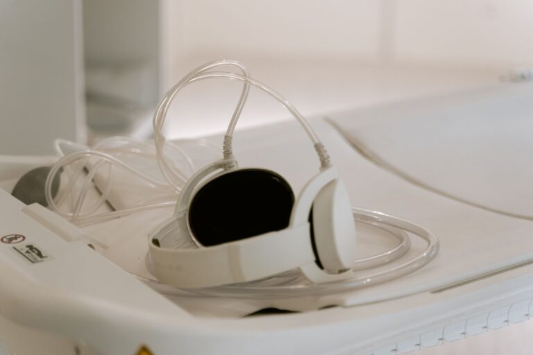 White headphones and tubing on a medical cart, typical in MRI settings.